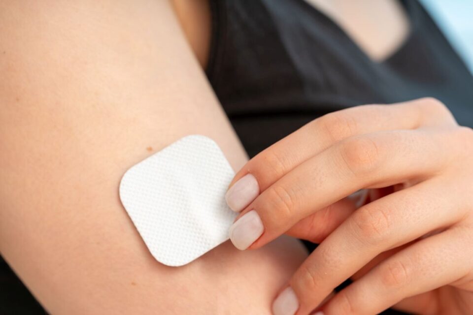 Transdermal patch using medical release liner on persons arm.