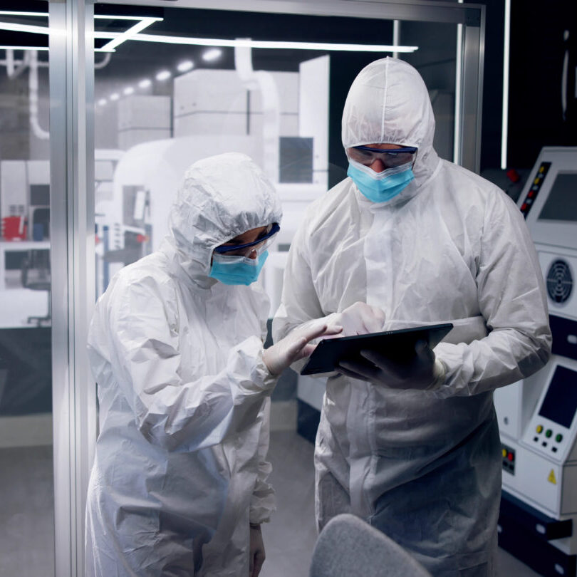 Clean room with two people working.