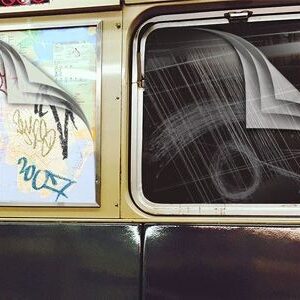 Multi-layered film on subway window.